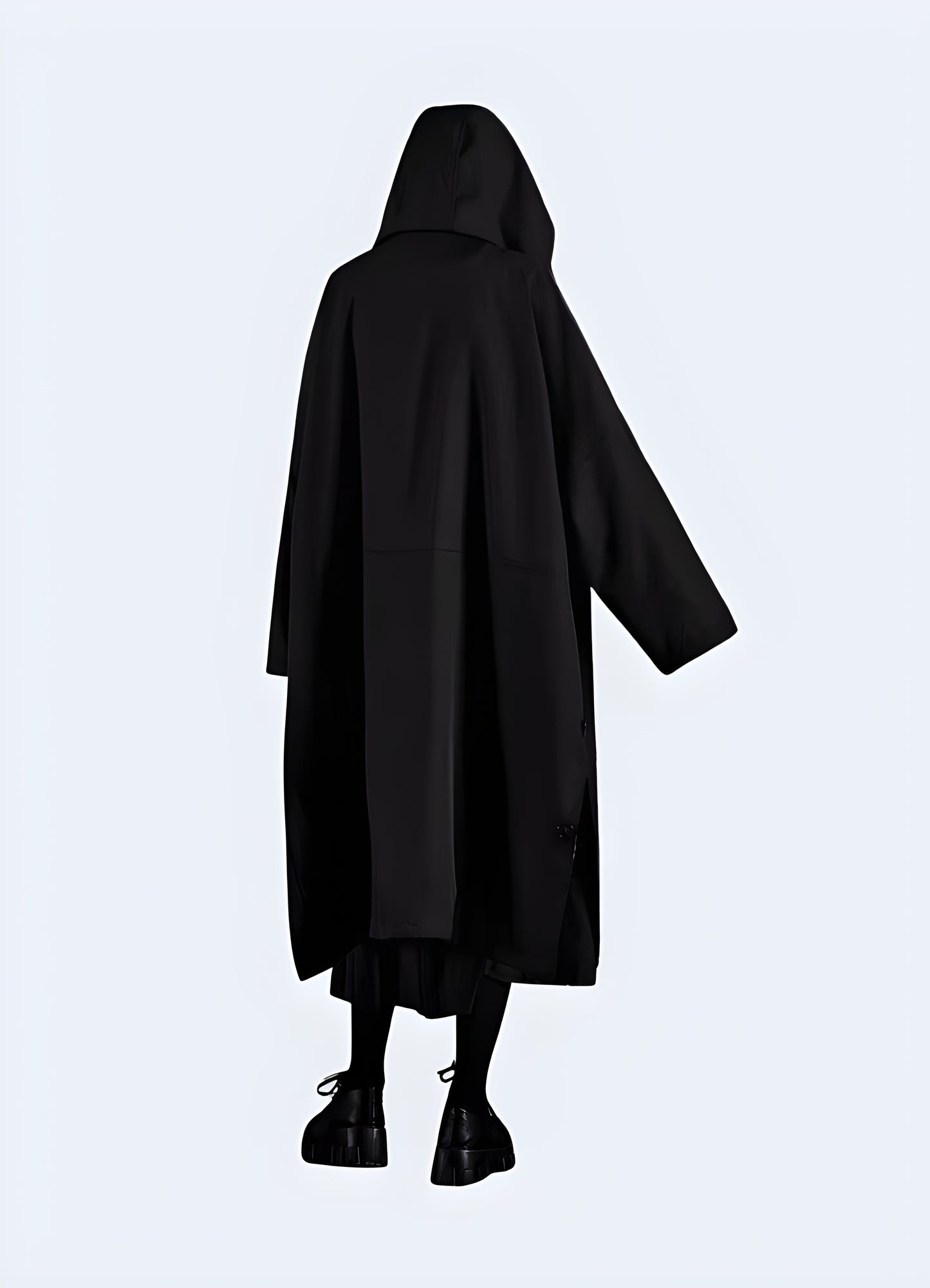 Back view of man wearing long black techwear jacket – waterproof functional streetwear coat with minimalist design