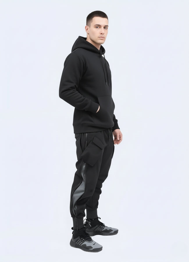 Techwear outfit featuring tactical black cargo joggers paired with hoodie and futuristic sneakers, minimalist white studio backdrop.