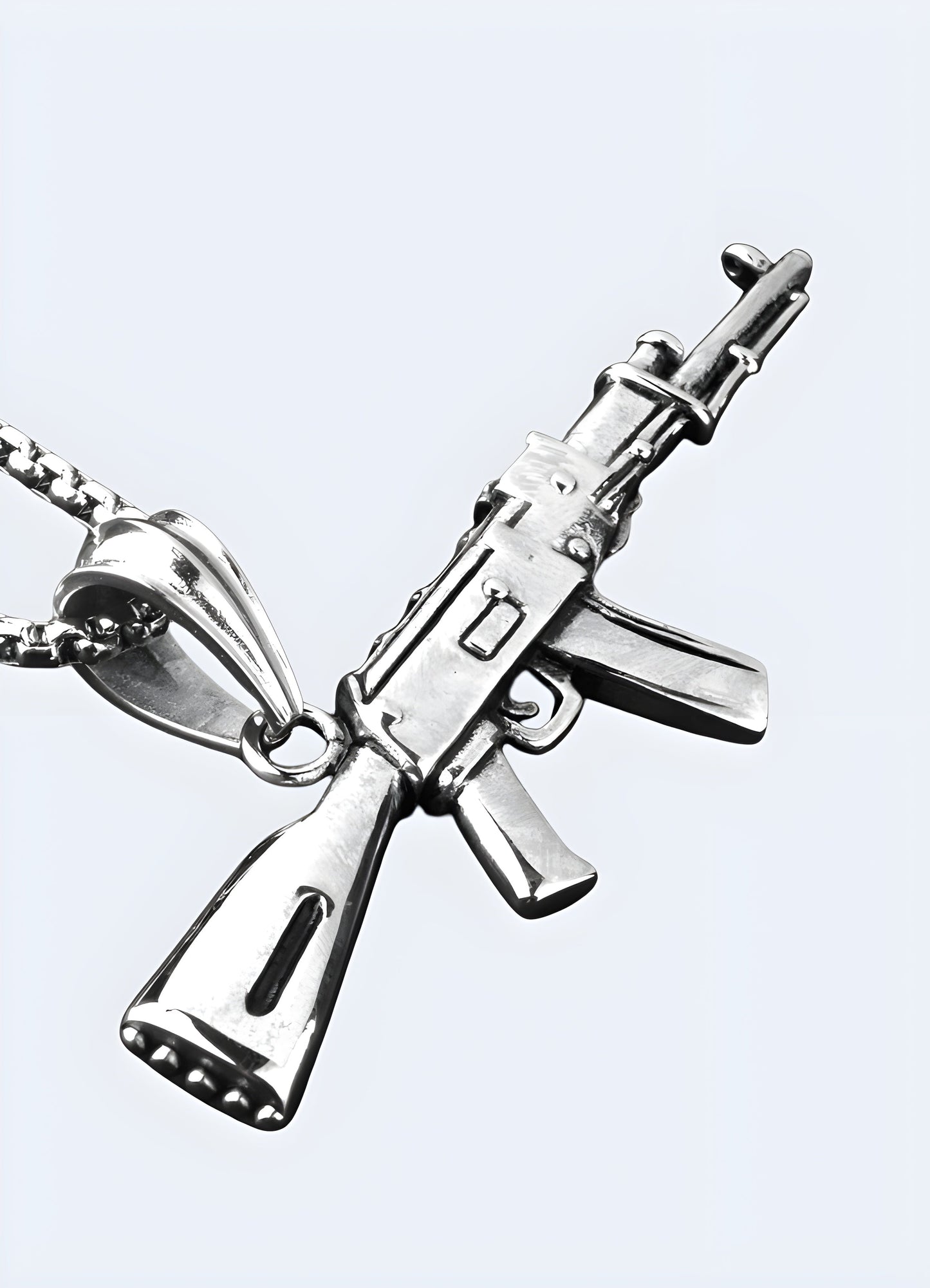 Silver AK-47 necklace shown from the front and side view, featuring a detailed pendant in the shape of the iconic firearm.