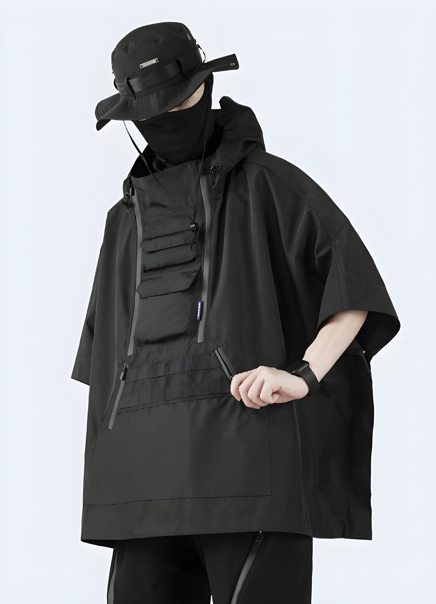 Model wearing a black cape jacket, showcasing the garment's elegant drape and movement from the left side view in the Canada.