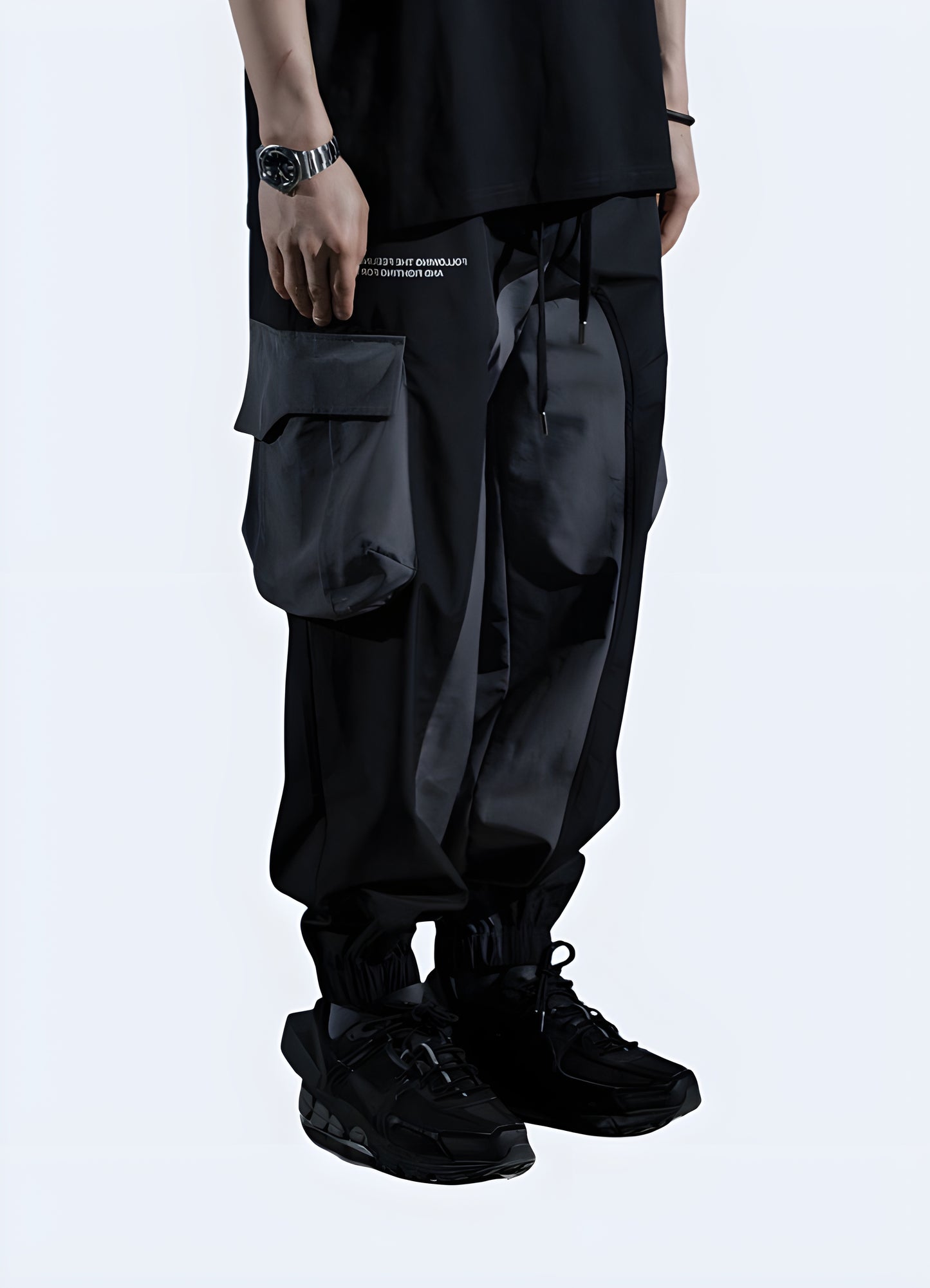 Front view of a man donning sleek black cyberpunk sweatpants, highlighting their modern style and versatility for fashion-conscious consumers in Canada.