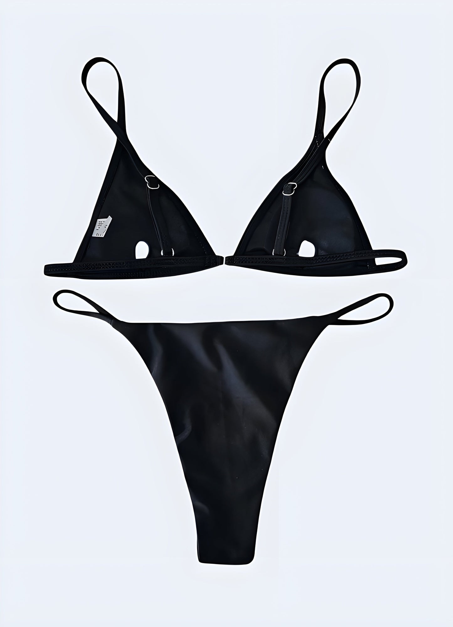 Rear view of a model wearing a goth bikini, showcasing intricate black straps and edgy design elements.