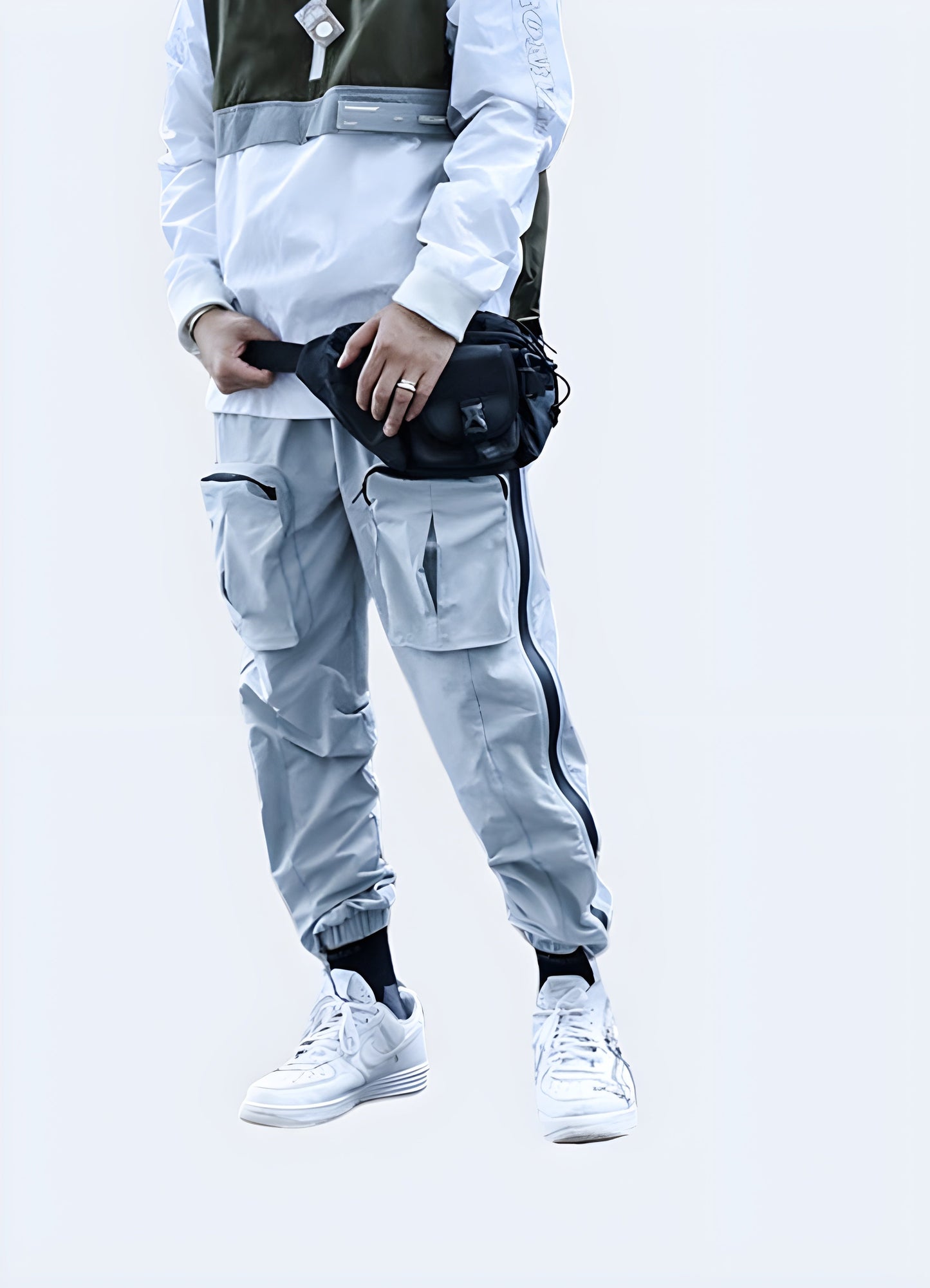 Man wearing grey avant-garde cargo pants, front view, demonstrating the perfect blend of cutting-edge design and functionality for Canadian fashion enthusiasts.