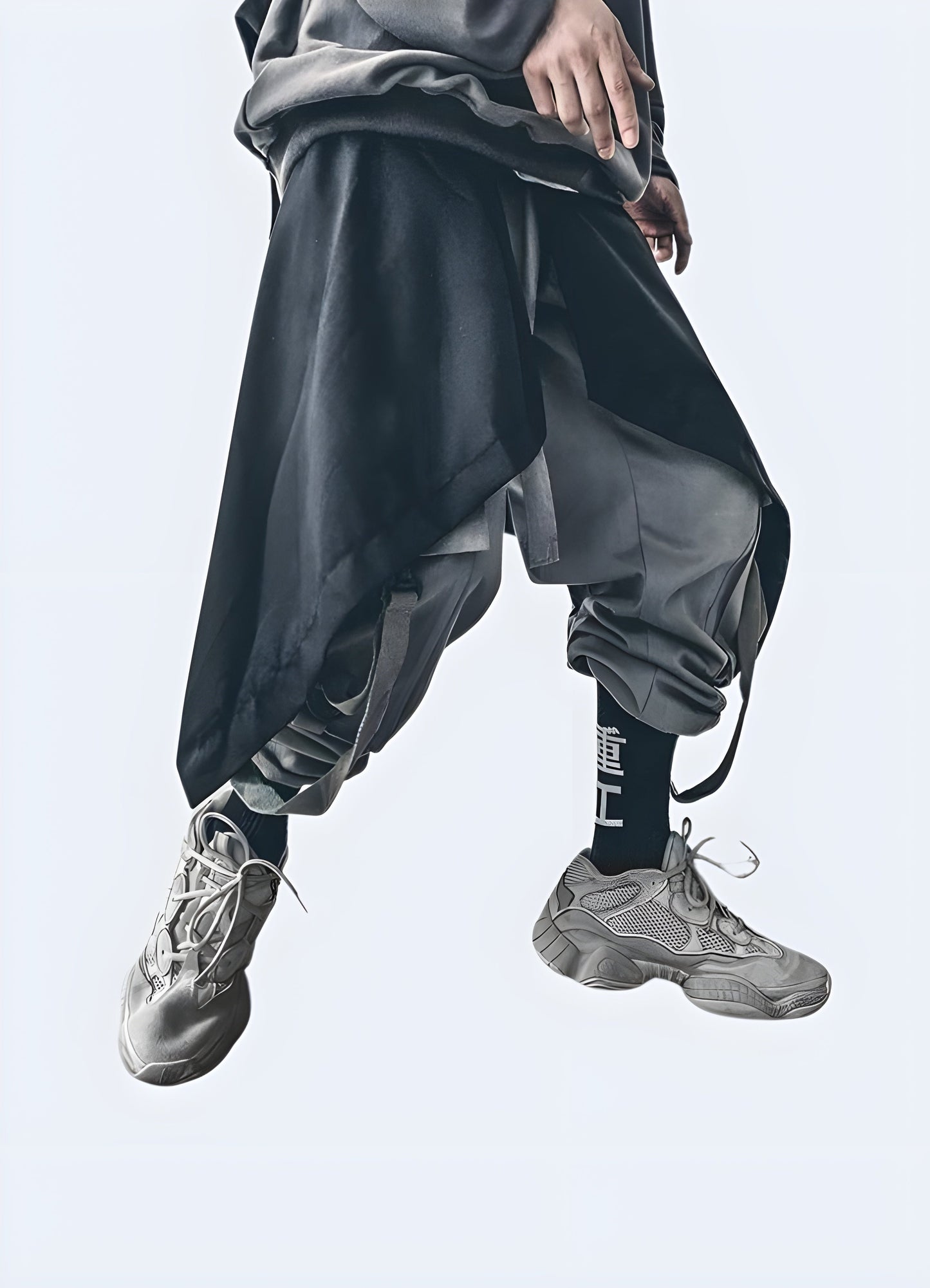 Front side view of man wearing black techwear men samurai skirt, featuring the contemporary style and versatile fit, perfect for the fashion-forward individual Canada.
