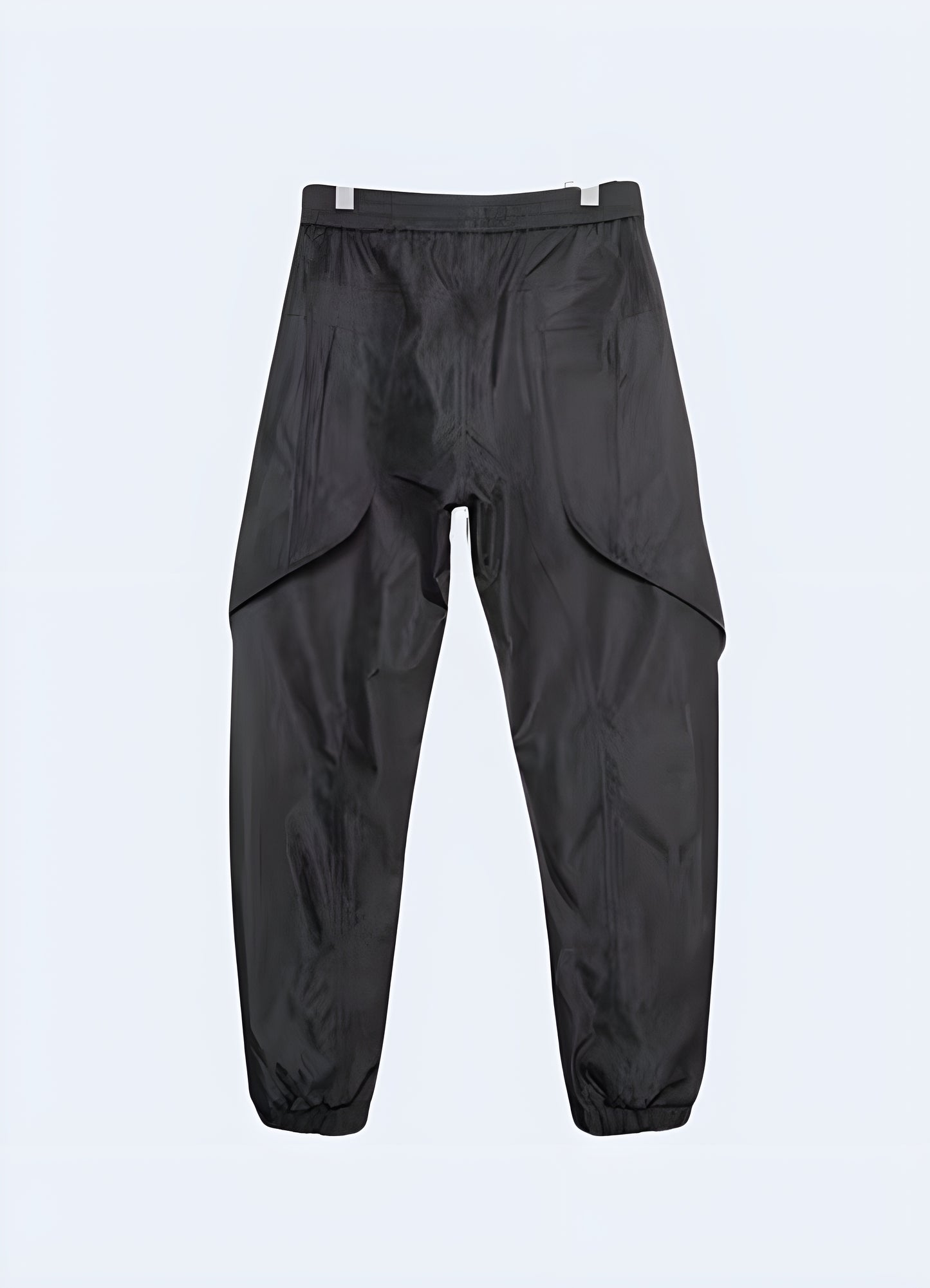 Rear view of a man sporting trendy cyberpunk-inspired pants in black with vibrant green details, perfect for Canada fashion enthusiasts.