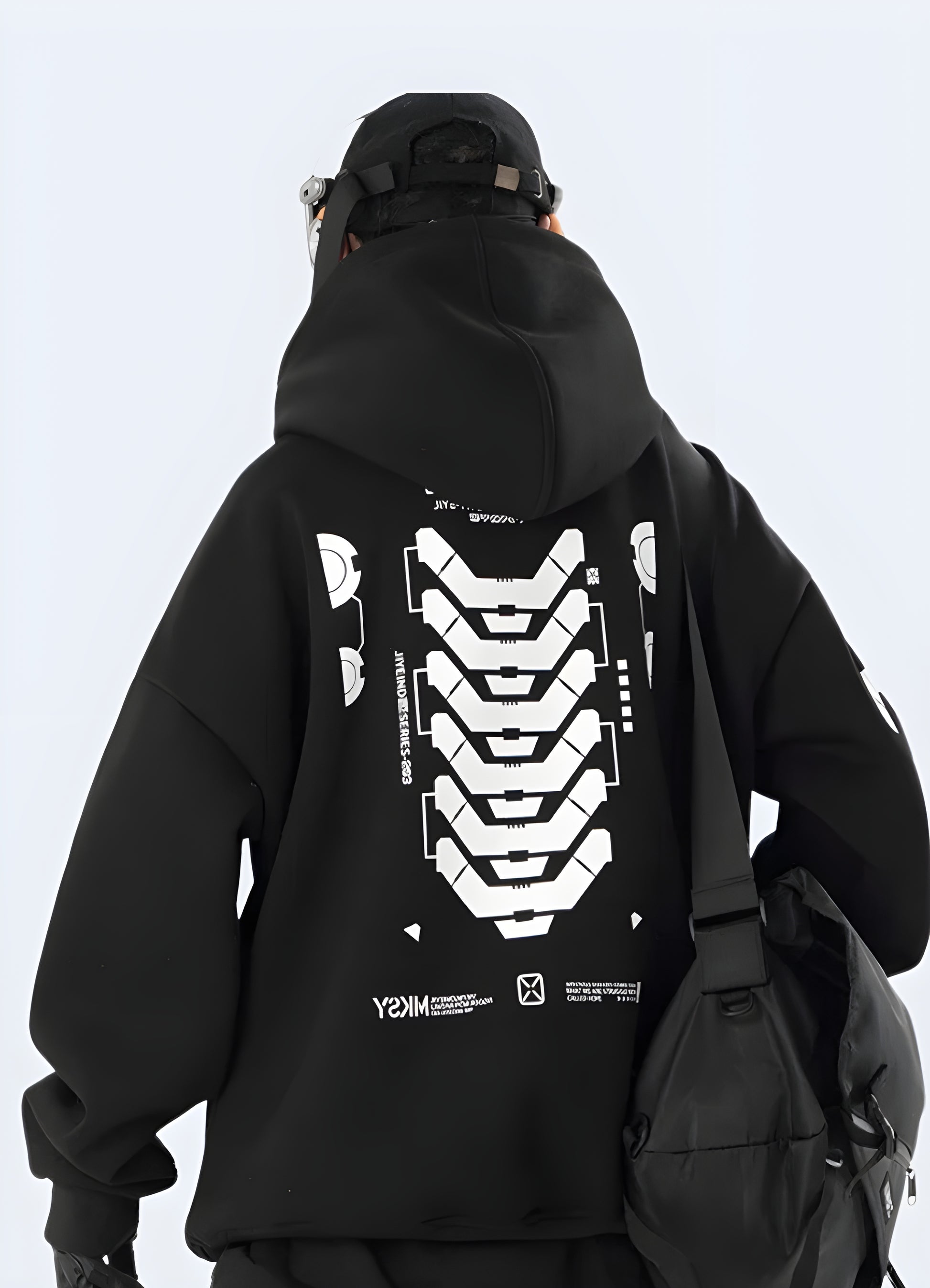 Back view of a man wearing a black graphic streetwear hoodie featuring a striking, eye-catching design, ideal for urban fashion enthusiasts.