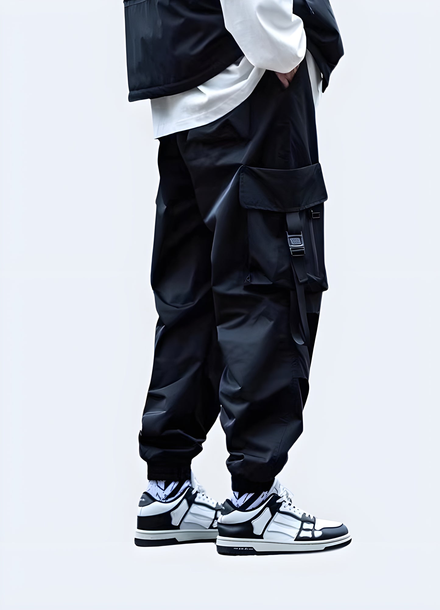Man wearing black Japanese techwear cargo pants with adjustable straps and tapered fit, back view, Canada fashion.