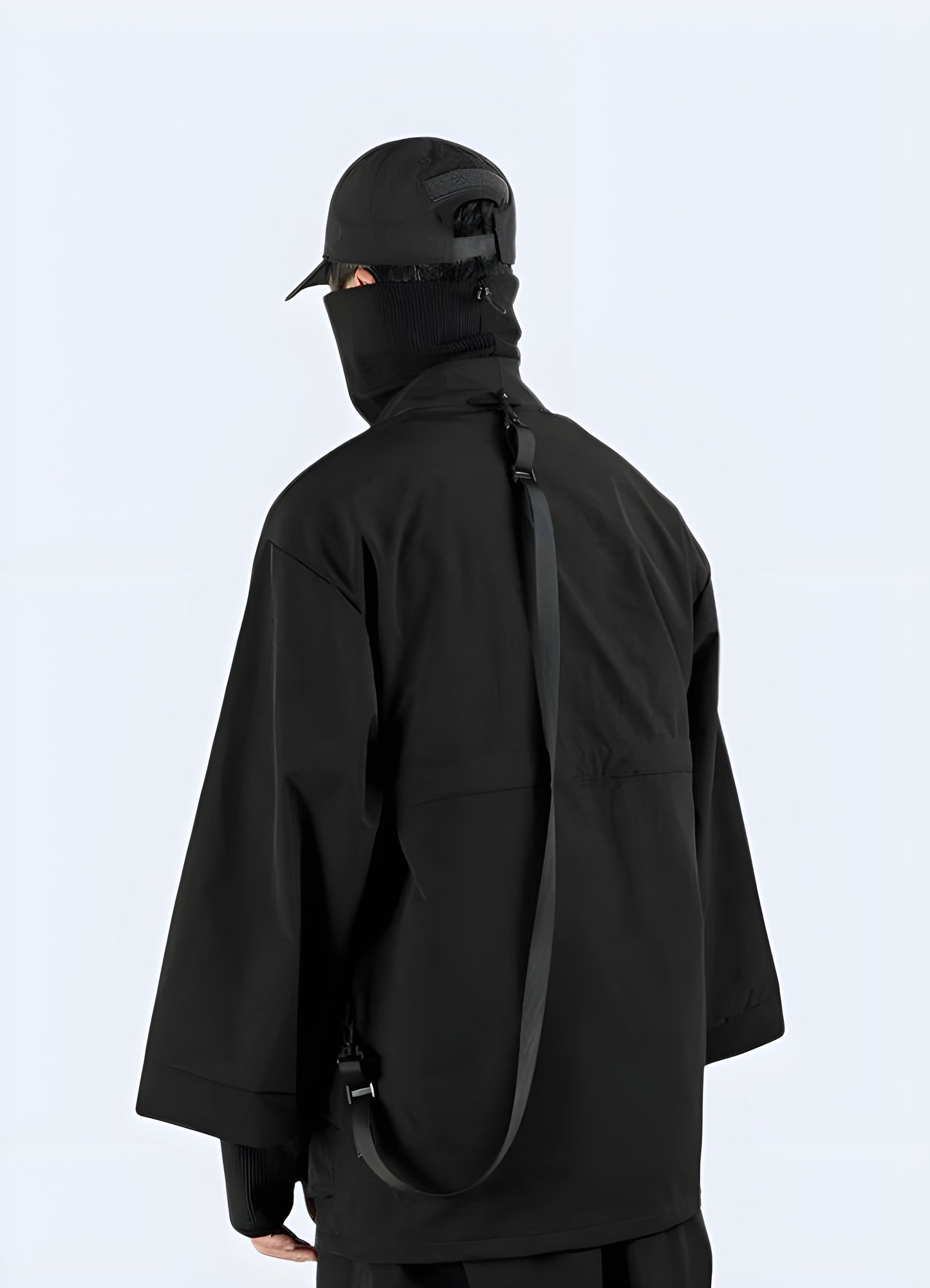 Back view of a man wearing a long black kimono jacket, showcasing the flowing silhouette and attention to detail, ideal for the UK fashion-forward individual looking to embrace cultural style.