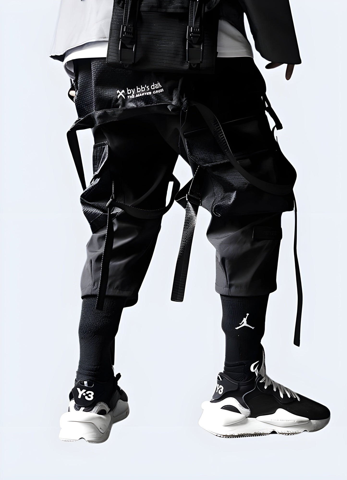 Rear view of a man modeling fashionable black streetwear pants, showcasing the garment's premium quality and attention to detail, ideal for the Canada streetwear scene.