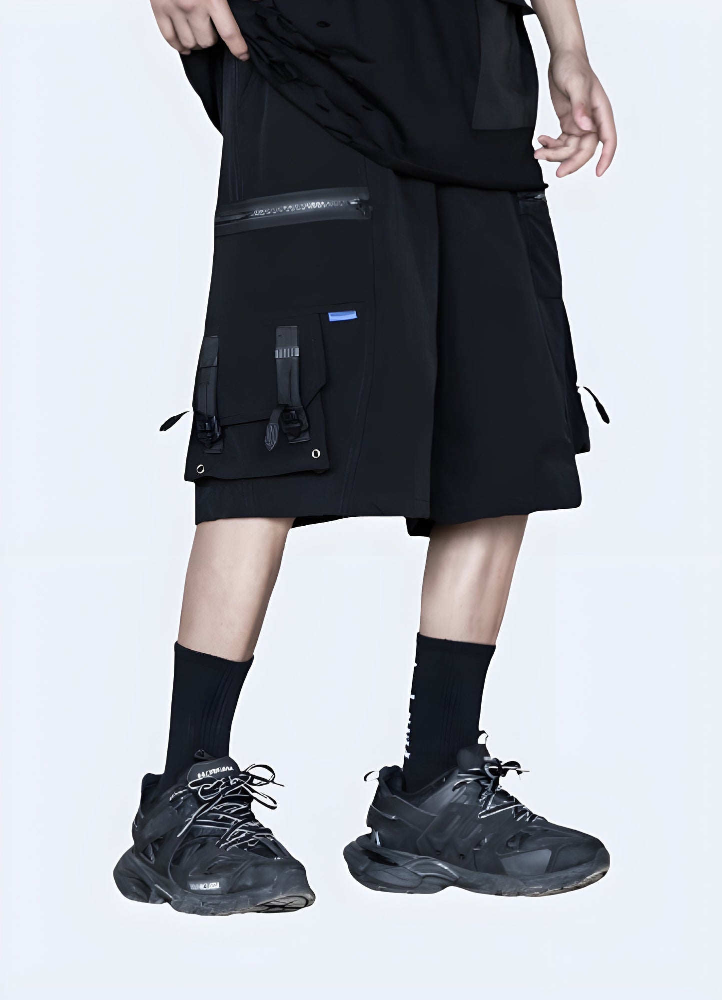 Front view of a man wearing tech shorts with zipper pockets, showcasing the functional design and modern look, perfect for the urban adventurer.