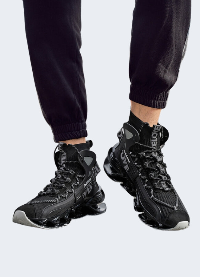 Man wearing stylish black and white techwear walking shoes while standing on a stone path in the Canada.
