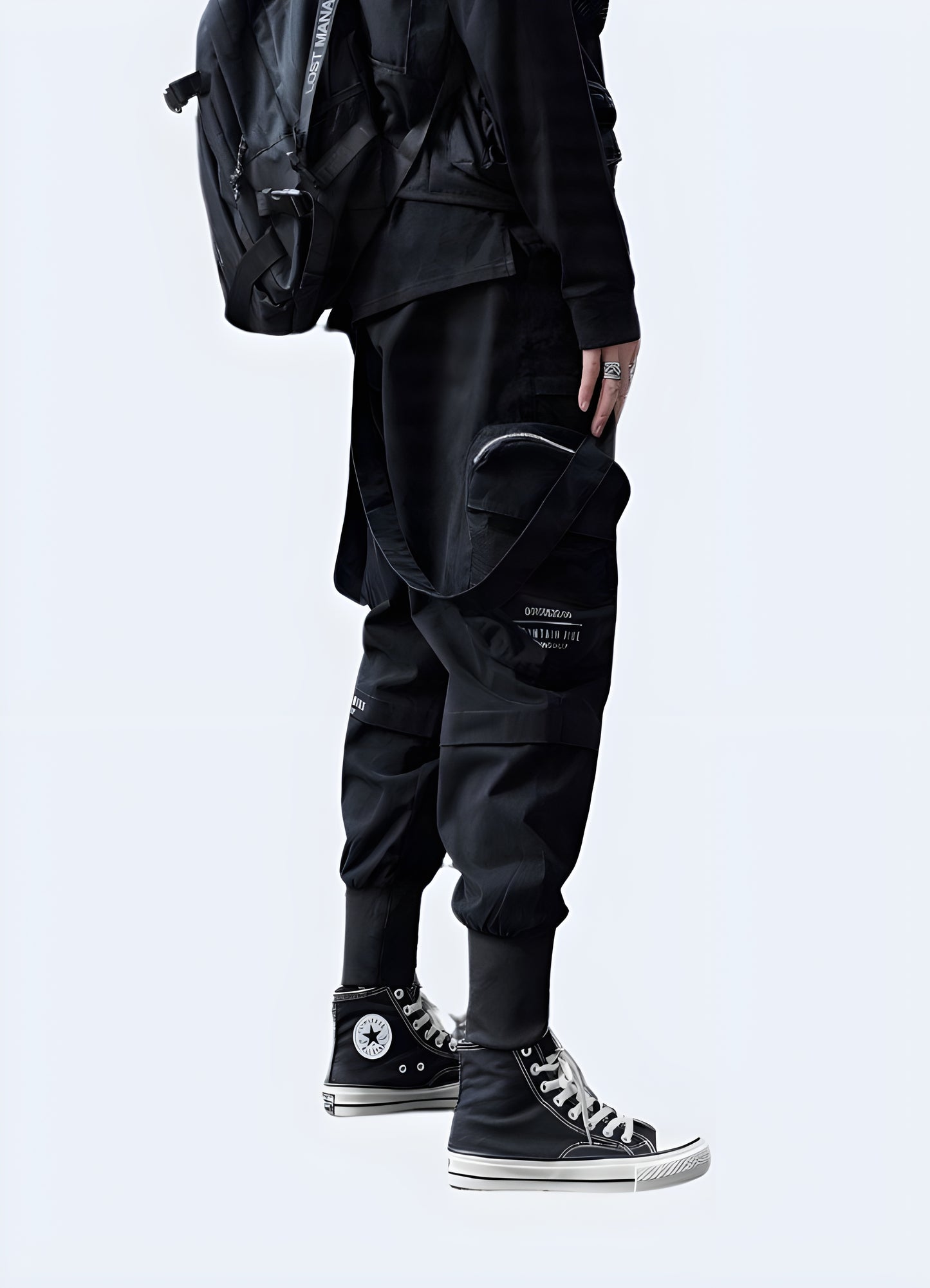 Side view of a man wearing versatile techwear cropped pants, showcasing their modern silhouette and practical design for active individuals in Canada.