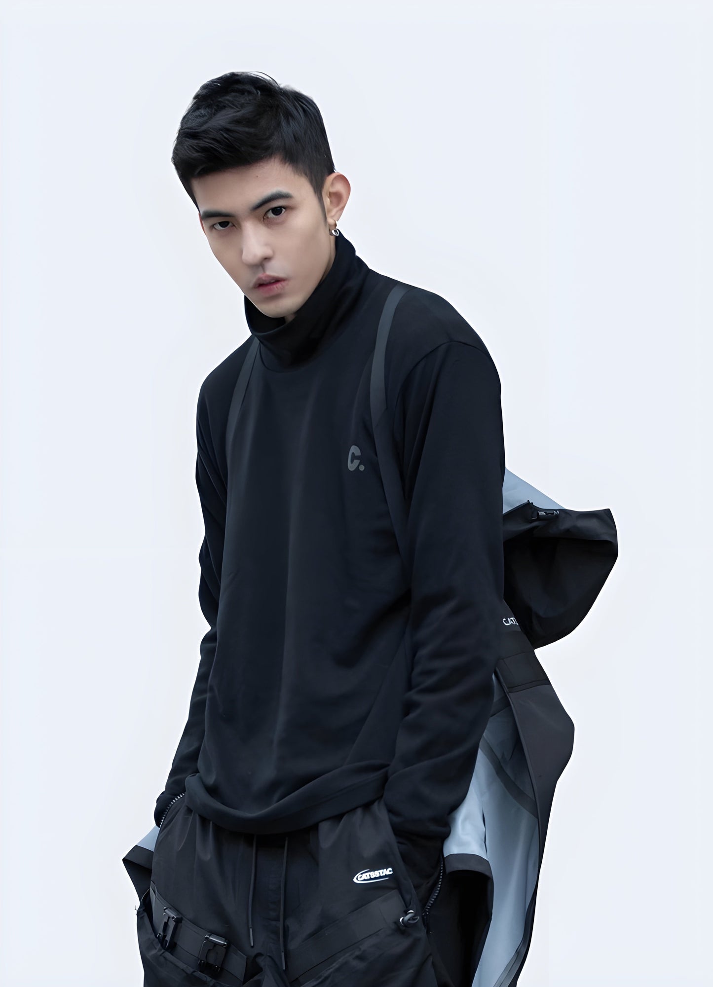 Front side view of a man wearing a techwear long sleeve shirt, showcasing its sleek design and functional features, ideal for navigating the urban landscape in style in the canada.