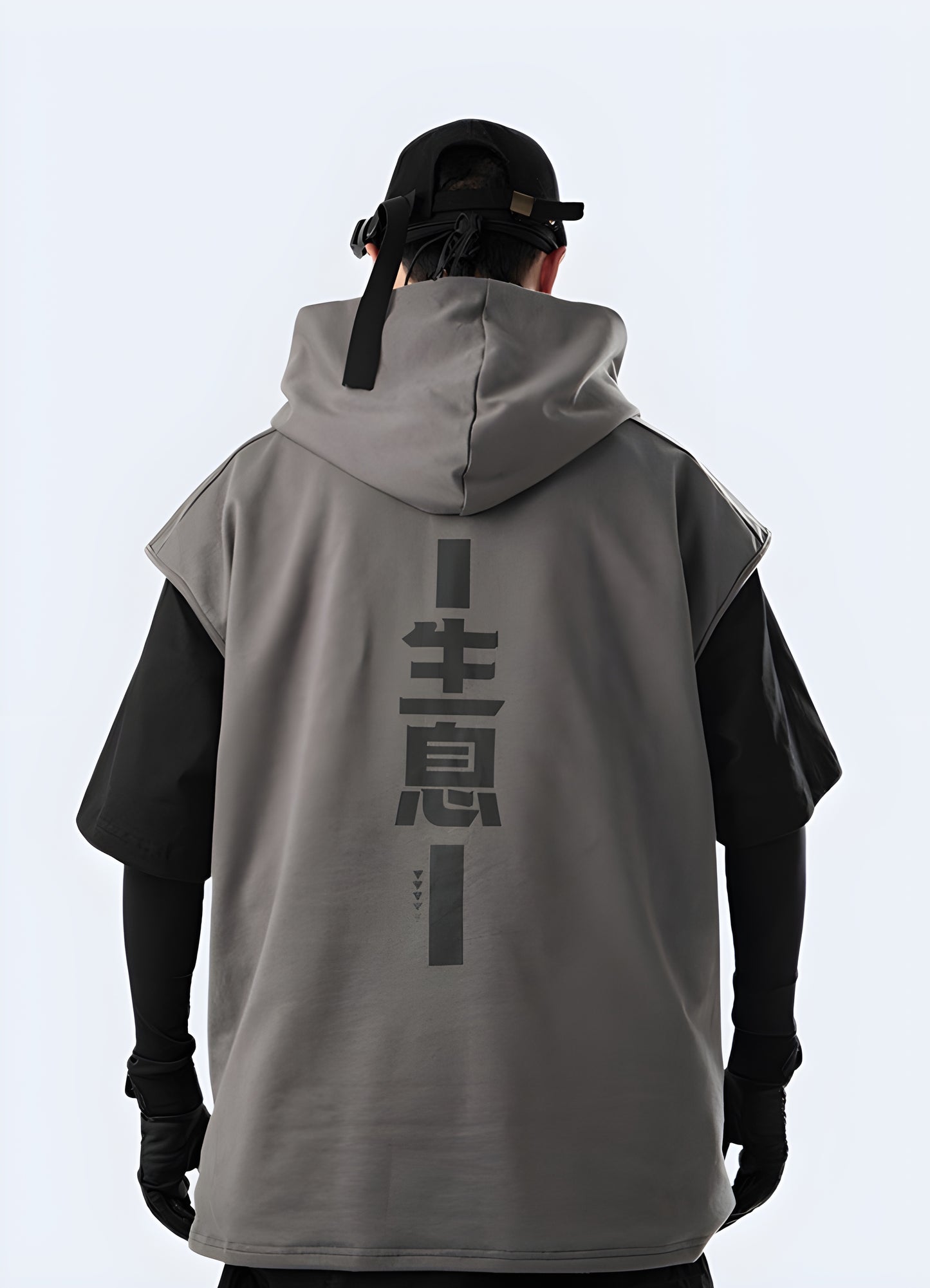 Man wearing a techwear sleeveless hoodie in front view, illustrating the fit and streetwear style of this trendy apparel available in Canada.