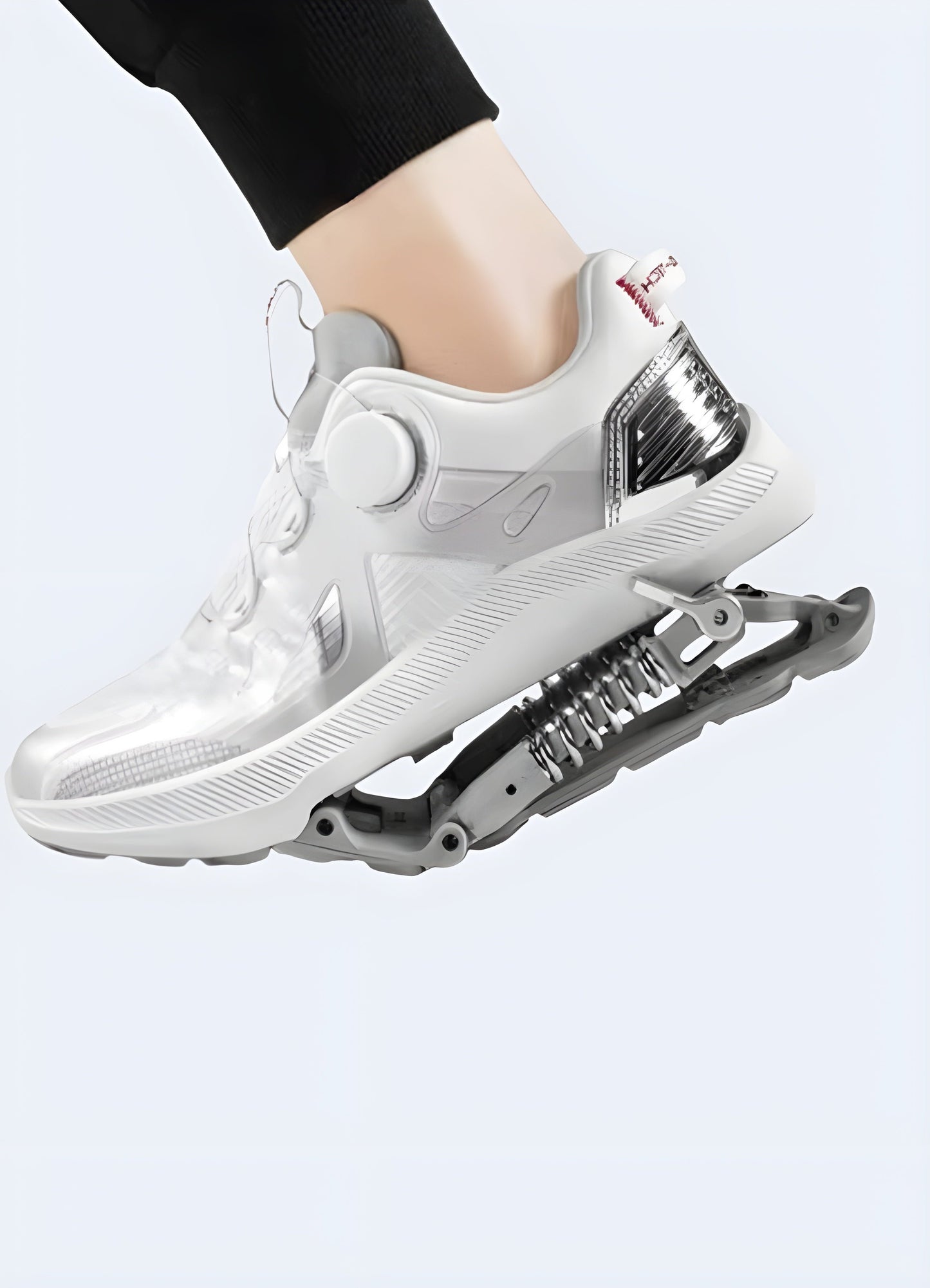 Man wearing white mechanical-assisted sneakers, showcasing the sleek design and mechanical features from a side view, perfect for techwear fashion in the Canada.
