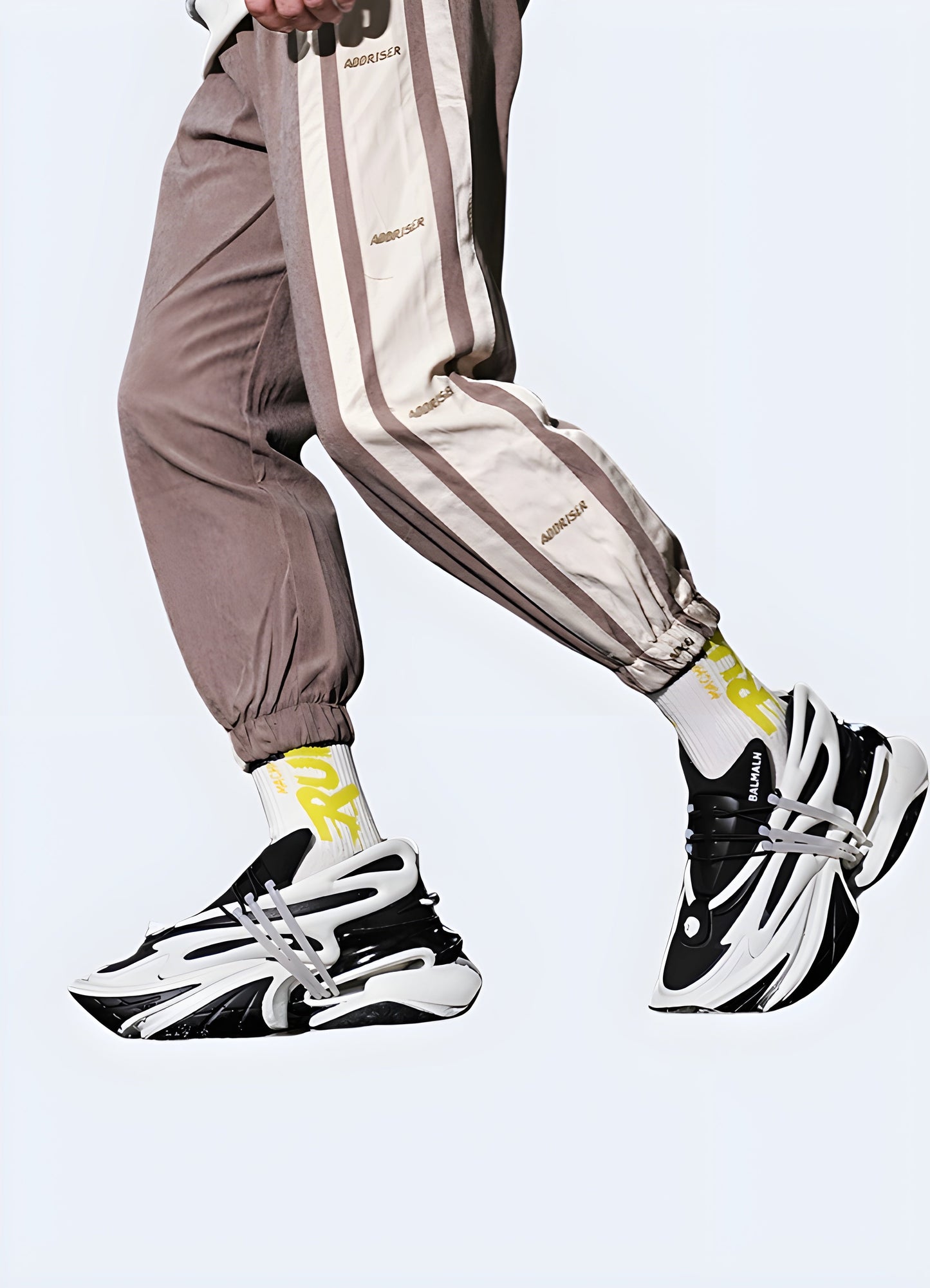 Side view of a men wearing reflective techwear sneakers in white and black, showcasing their modern style and enhanced visibility features, ideal for navigating Canada urban environments.