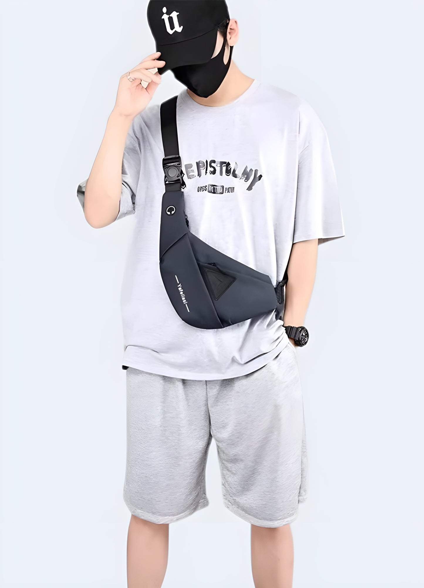 A man wearing a tactical crossbody bag, viewed from the front. The bag has a rugged design with multiple compartments and is worn across the body with an adjustable strap canada.