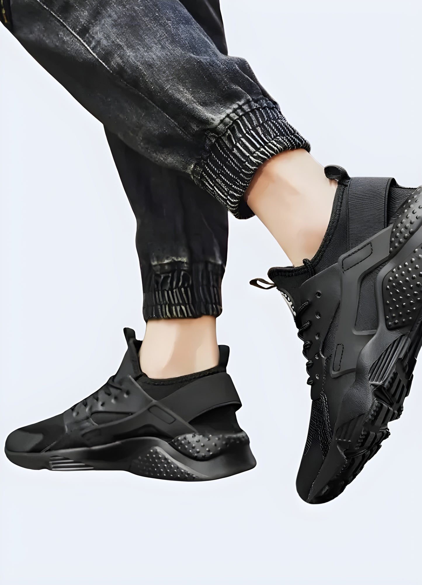 Man wearing black streetwear sneakers while posing, demonstrating the shoes' style and versatility for urban fashion in the Canada.