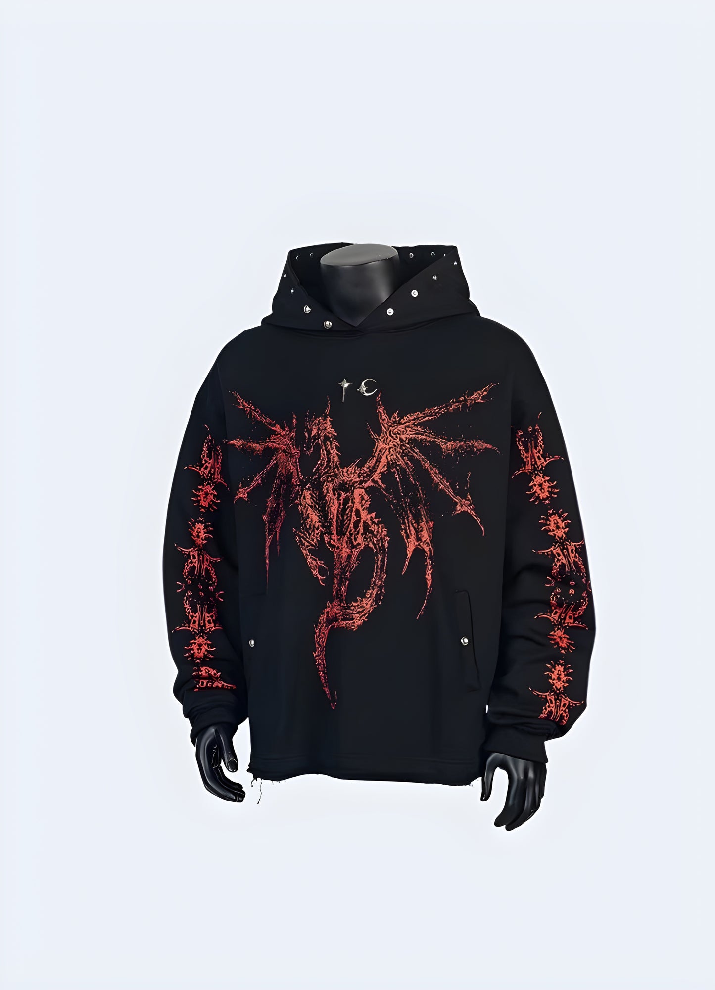 A person wearing a black hoodie with a skull design, standing on a city street at night.