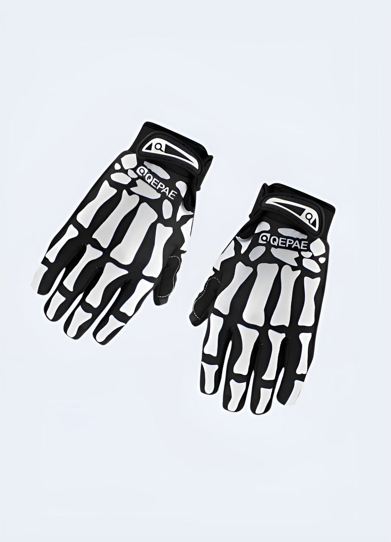 A pair of black tactical gloves featuring a skull design on the back of the hands. The gloves appear to be made from durable material suitable for combat or tactical use Canada.