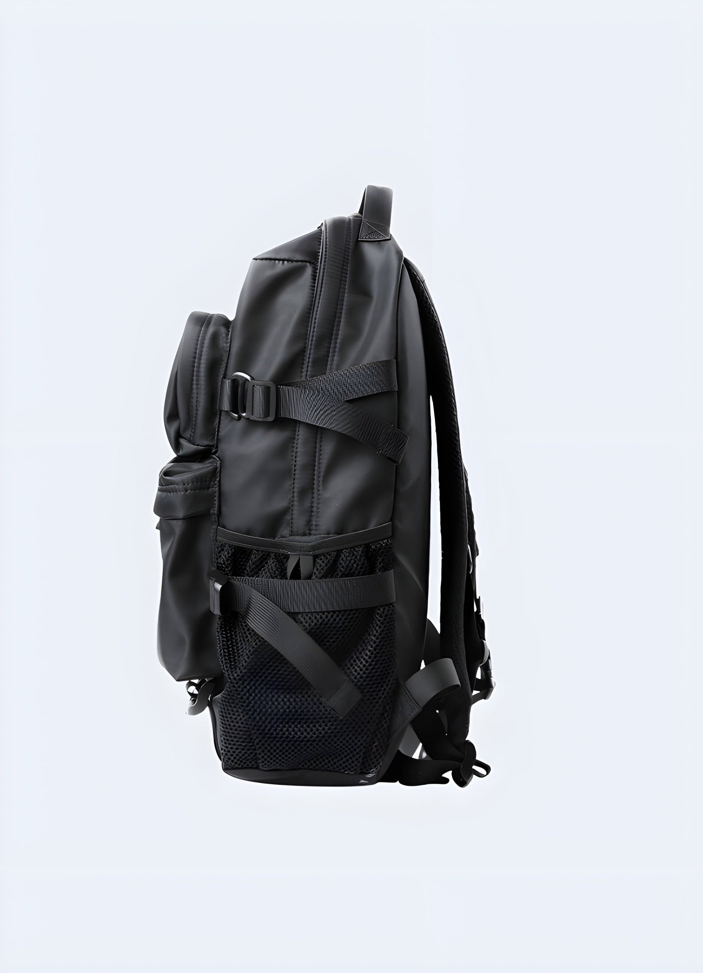 Side view of a model wearing a techwear backpack. The backpack is sleek with a matte black finish, featuring a streamlined profile and side pockets Canada.