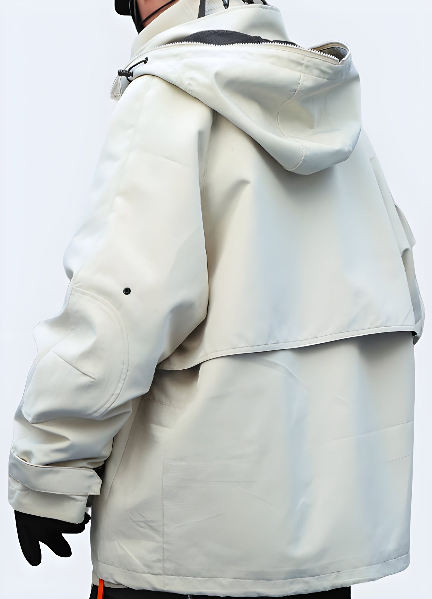 Back view of a waterproof techwear rain jacket, showcasing its technical design and functionality in the Canada.