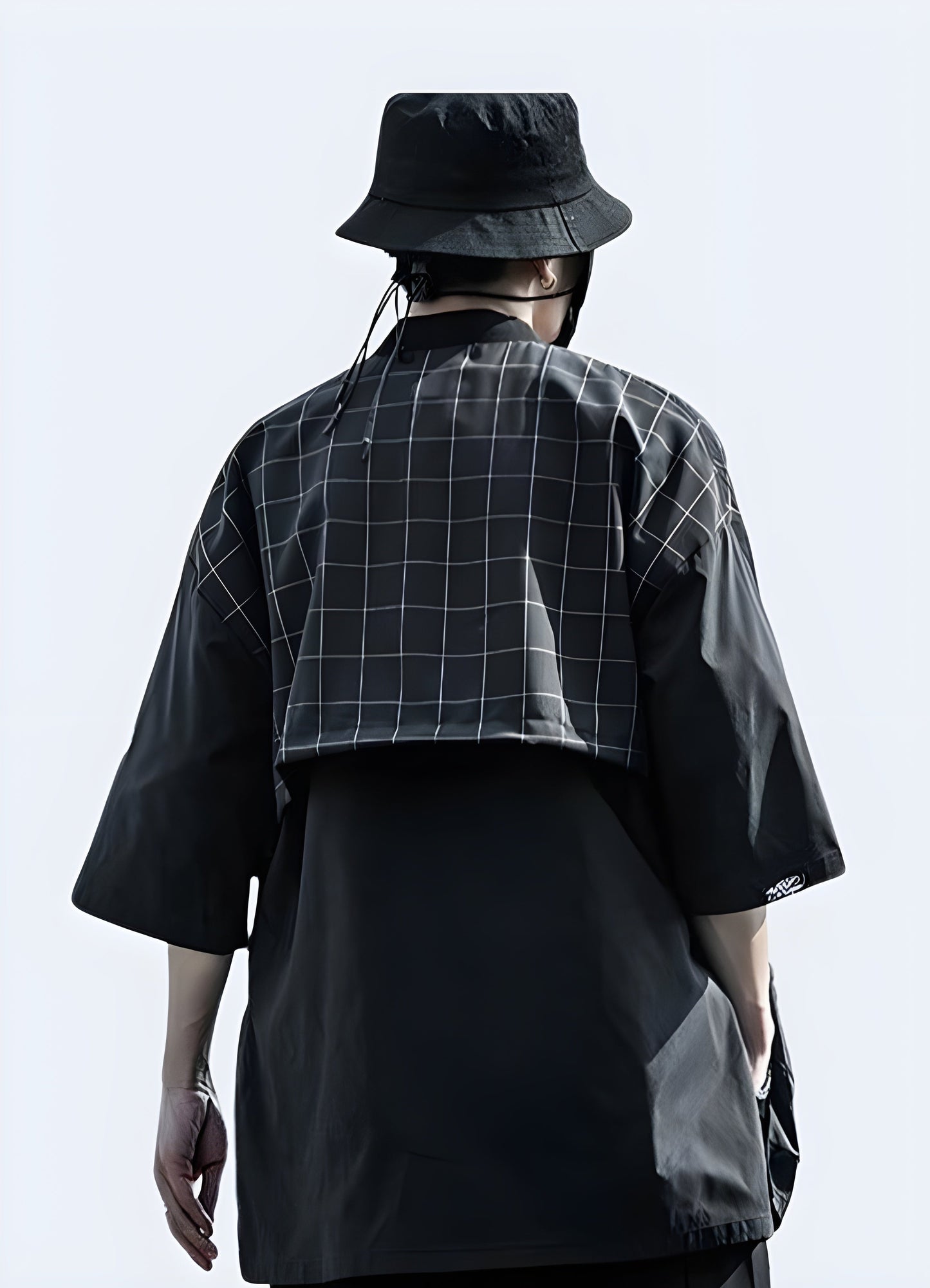 Back view of a figure wearing a classic traditional black Japanese kimono, emphasizing the intricate details, fine stitching, and the graceful drape of the silk fabric that embodies centuries of Japanese tradition Canada.