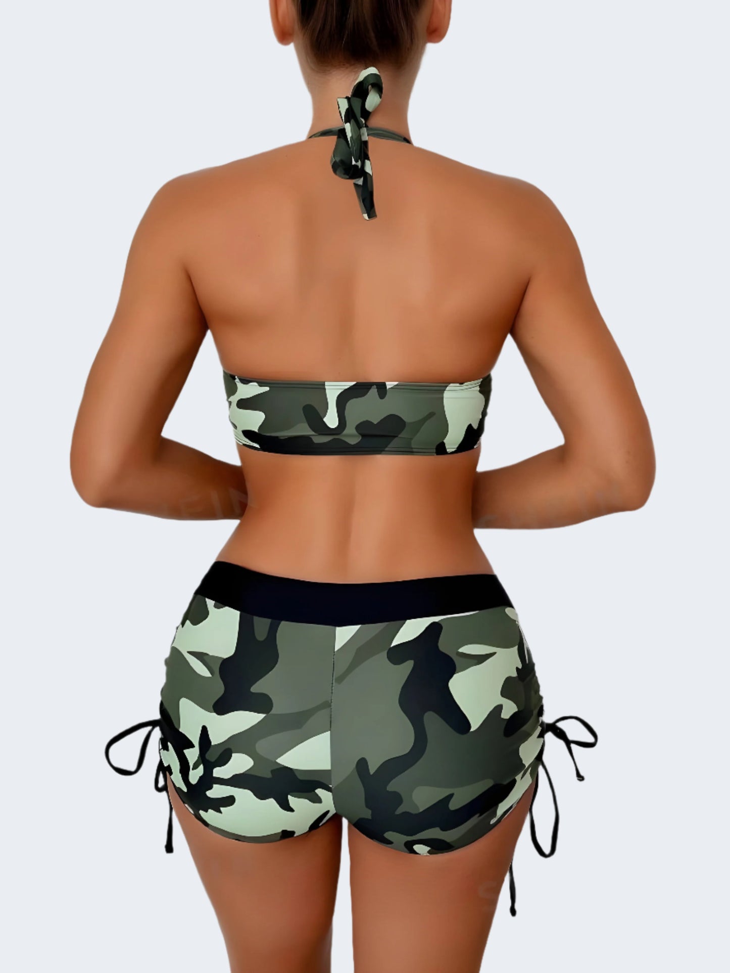 Beautiful woman confidently modeling a trendy camouflage bikini from the back view, showcasing the unique pattern and flattering cut of this must-have swimwear piece for adventurous summer style in the Canada.