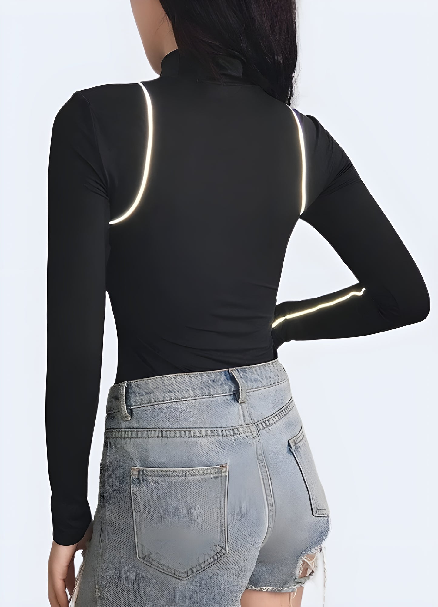 Back view of a woman wearing a classic black turtleneck bodysuit, highlighting its sleek, flattering fit and versatile design. Perfect for Canadian wearers looking for a timeless, wardrobe-essential piece that combines style and comfort.