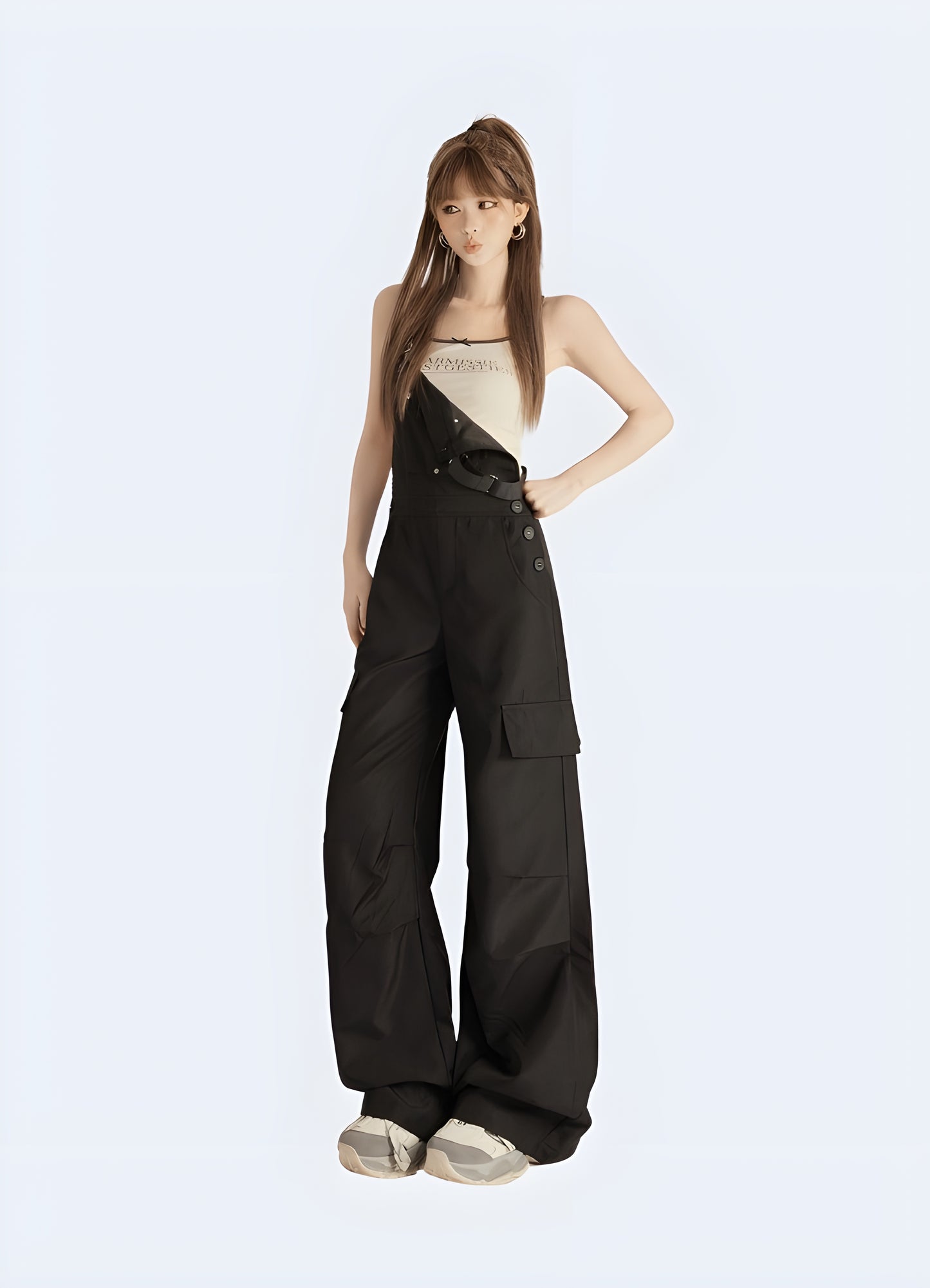 Model view of a woman in fashionable black techwear overalls with cargo pockets and straps, standing on a city street in Canada.