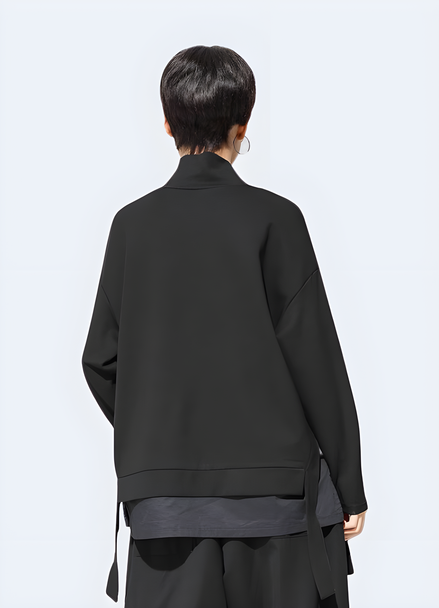 Woman wearing an asymmetrical sweatshirt in techwear style, back view, in Canada. Showcasing unique fashion and contemporary style.