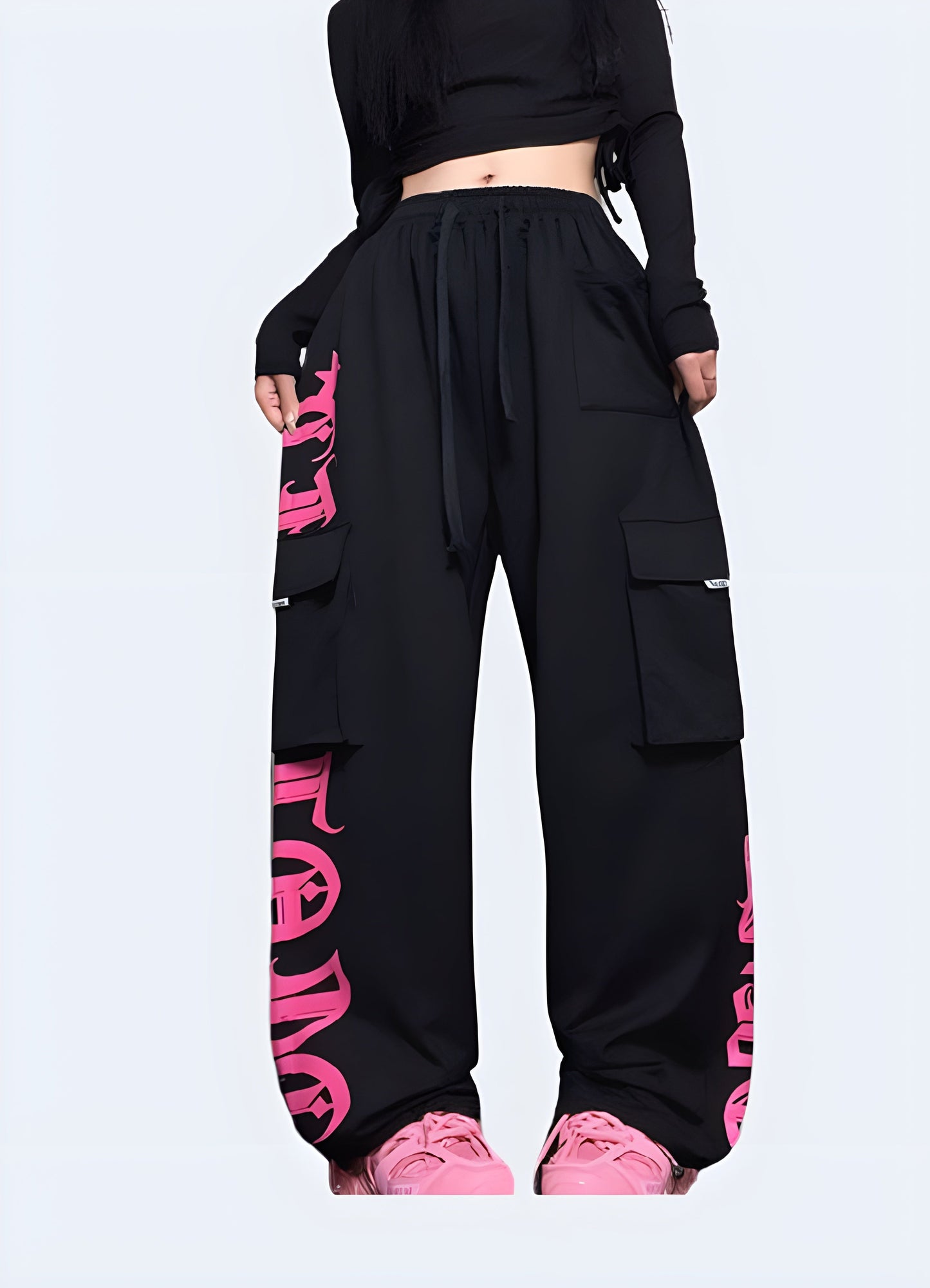 Stylish black techwear pants with contrasting pink pockets and trim, available for purchase in the Canada.
