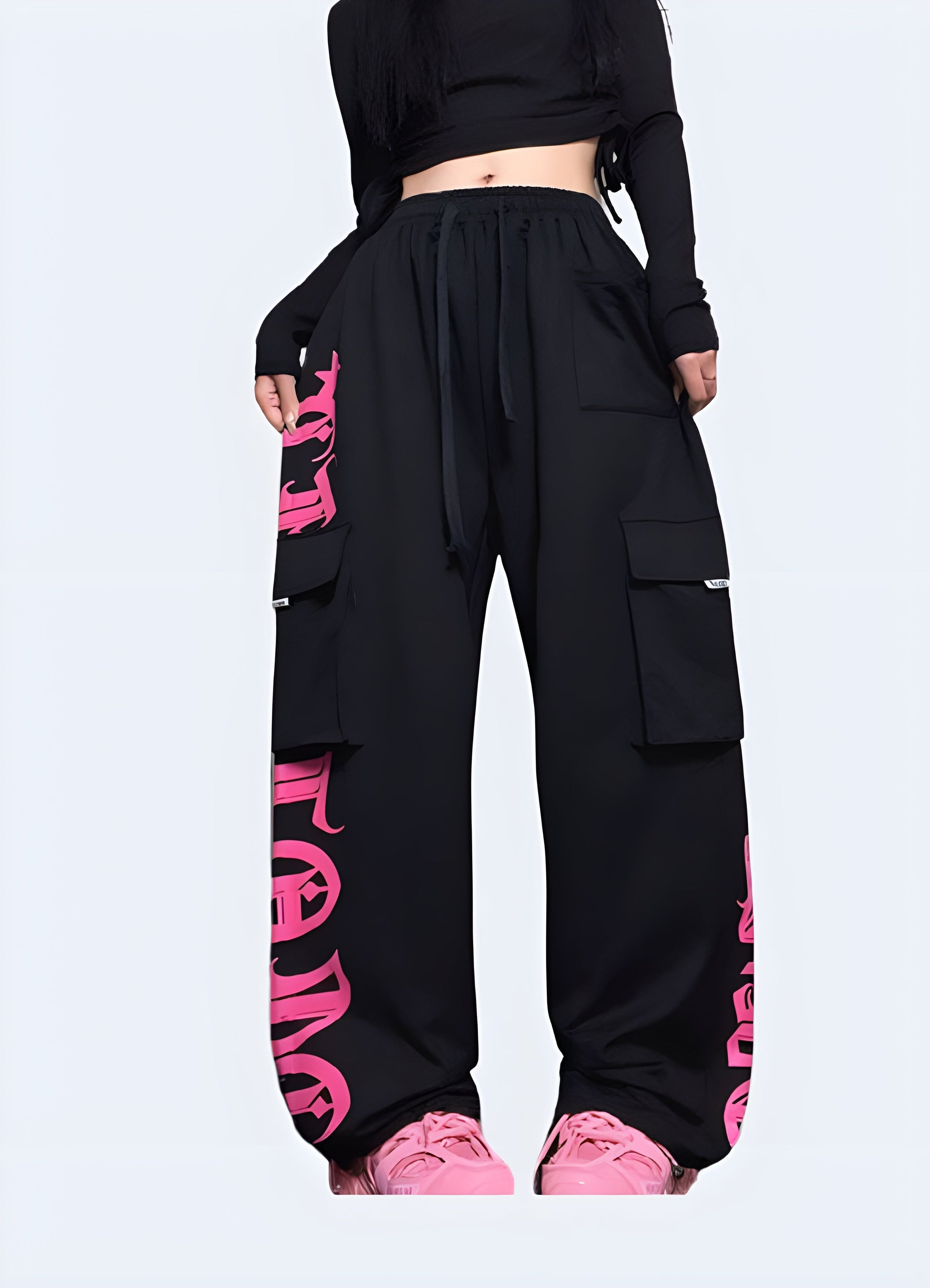 Stylish black techwear pants with contrasting pink pockets and trim, available for purchase in the Canada.