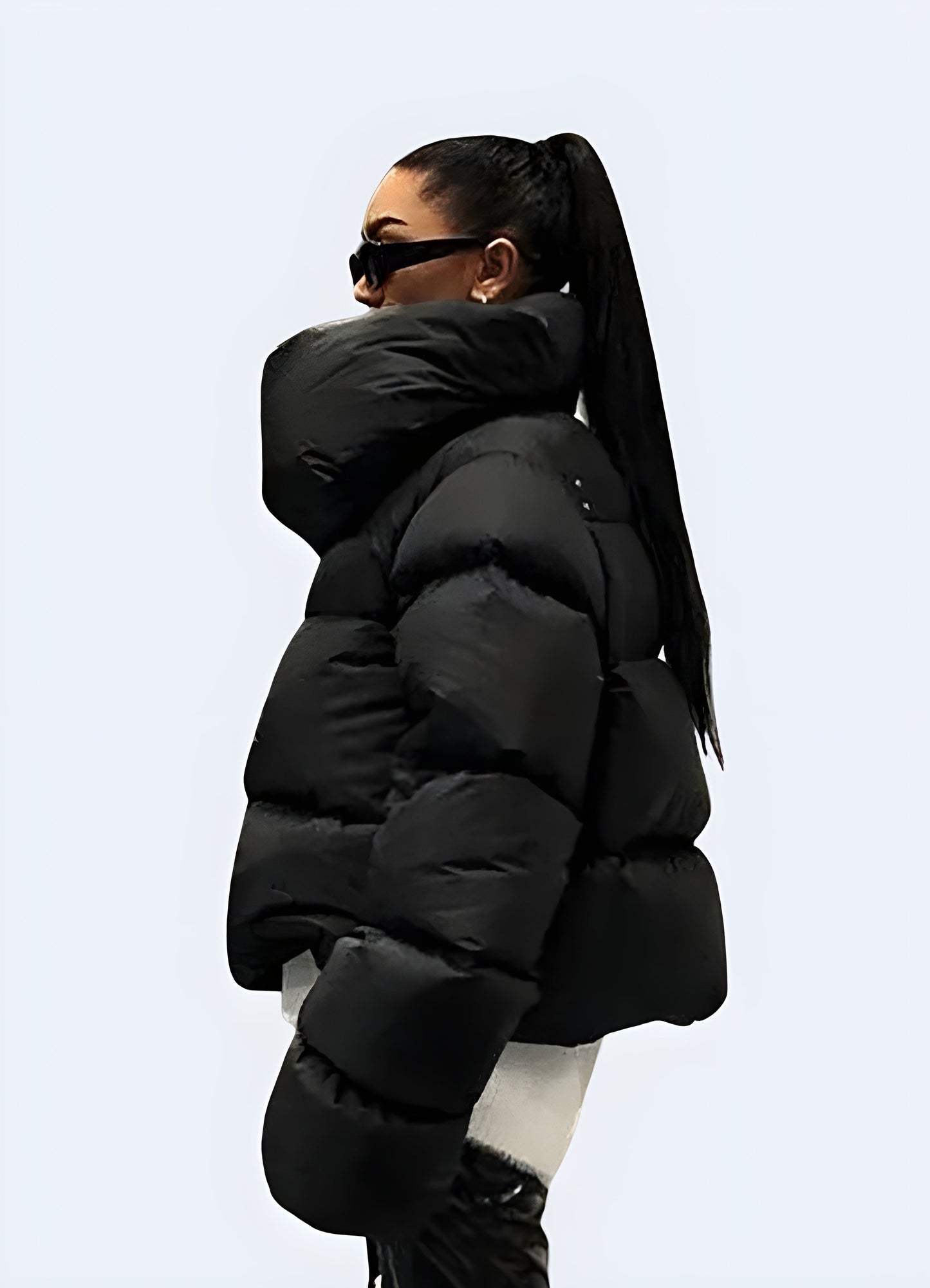 Side view of a woman wearing a techwear down puffer jacket, showcasing its sleek silhouette and functional features for cold weather in the Canada.