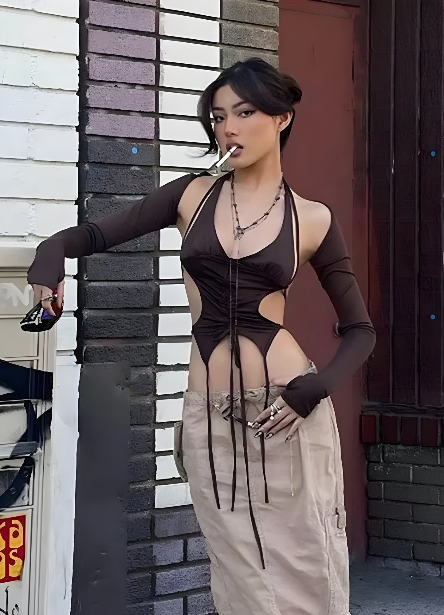 Front side view of a woman wearing a fashionable techwear lace-up crop top, showcasing contemporary style in Canada.