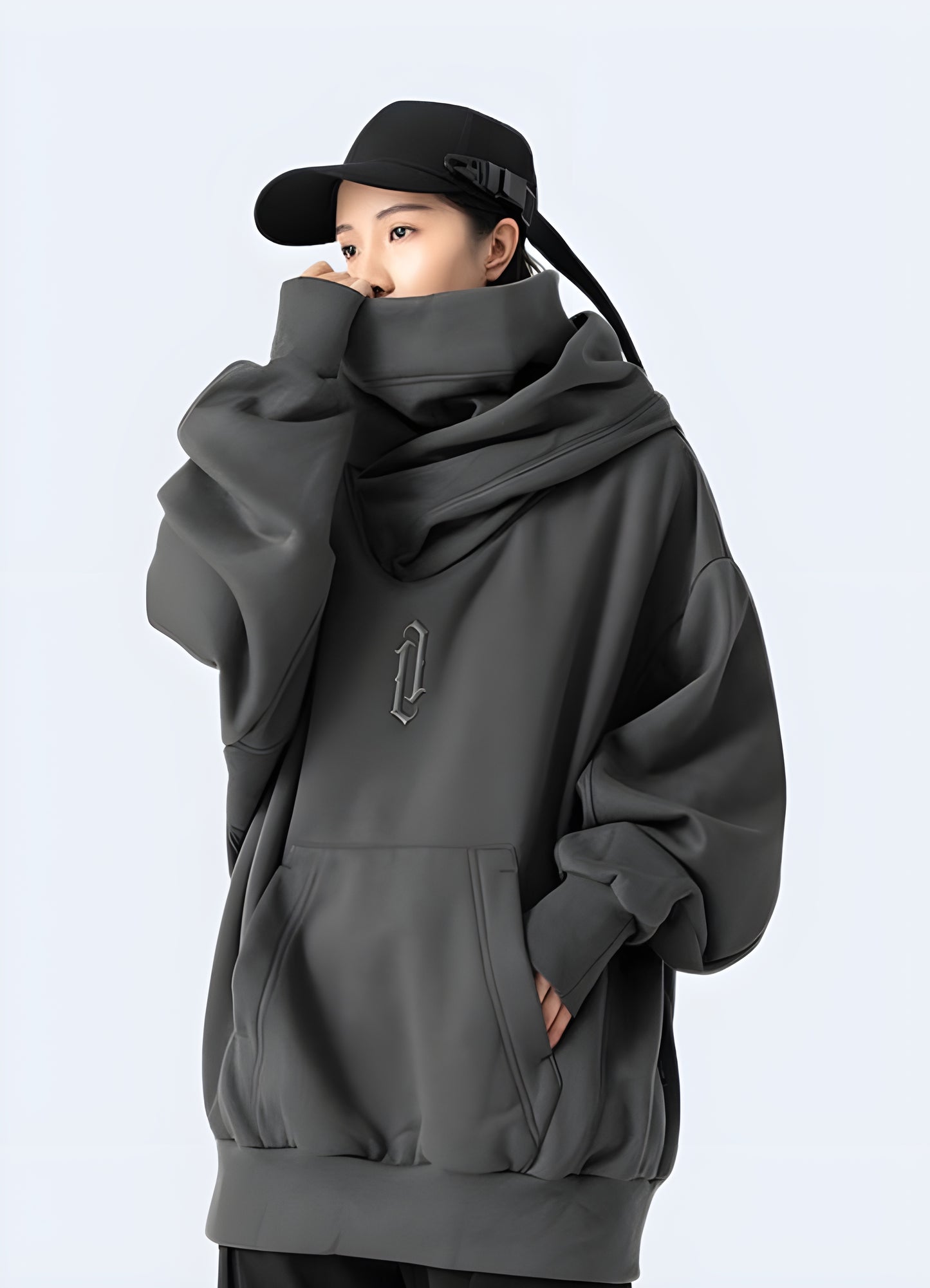 Woman wearing a grey comfortable Harajuku hoodie, front side view, in Canada. Trendy and casual look for everyday wear.