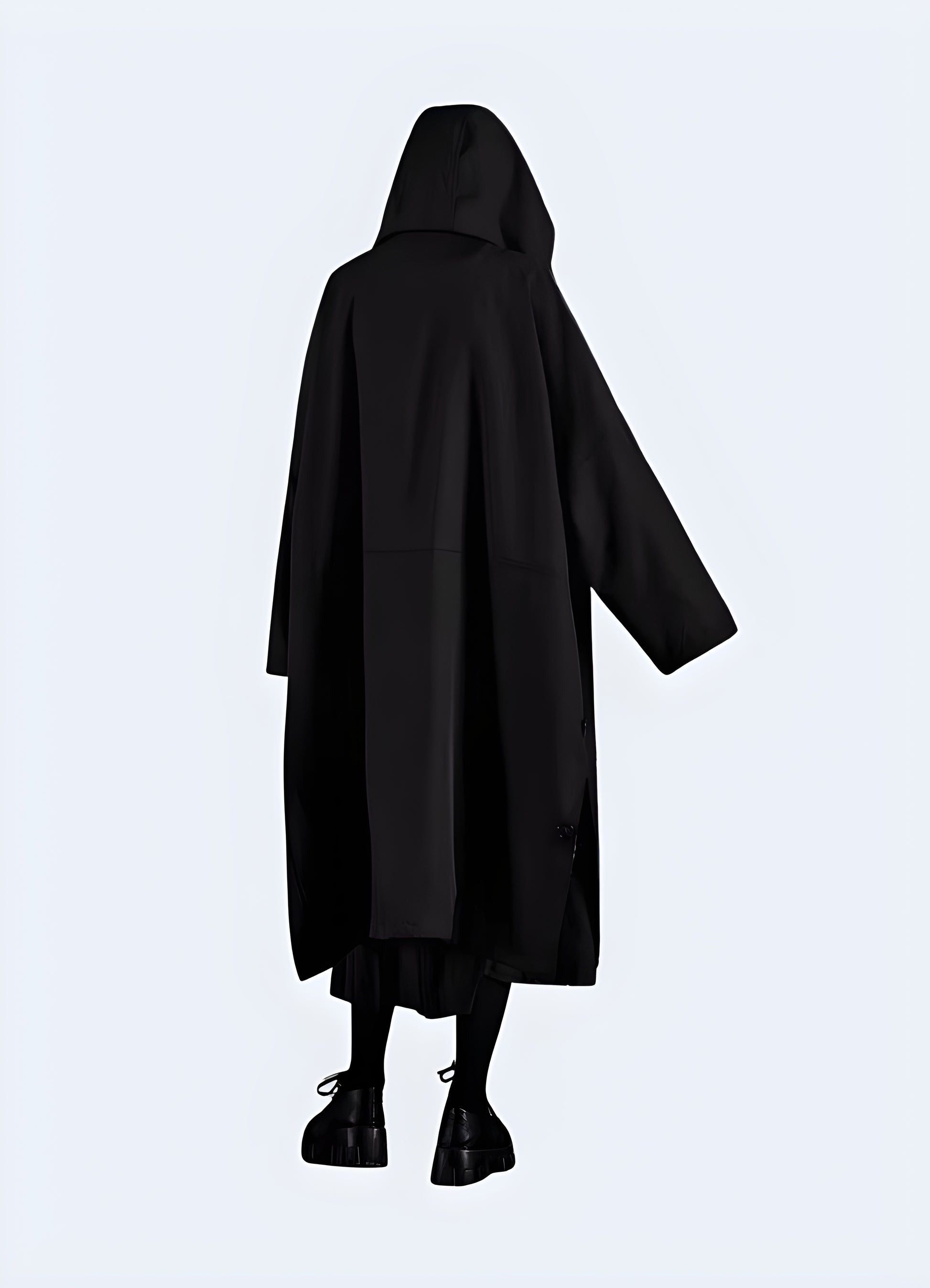 Back view of man wearing long black techwear jacket – waterproof functional streetwear coat with minimalist design