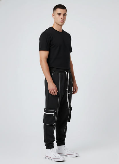 Side angle of black techwear pants featuring reflective seams, cargo pockets, and modern tapered fit.