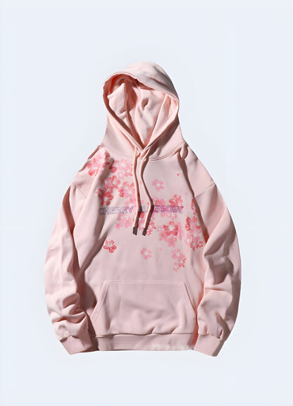 Woman wearing a women's Sakura Harajuku hoodie, pink, front view, fashionable urban style in Canada.