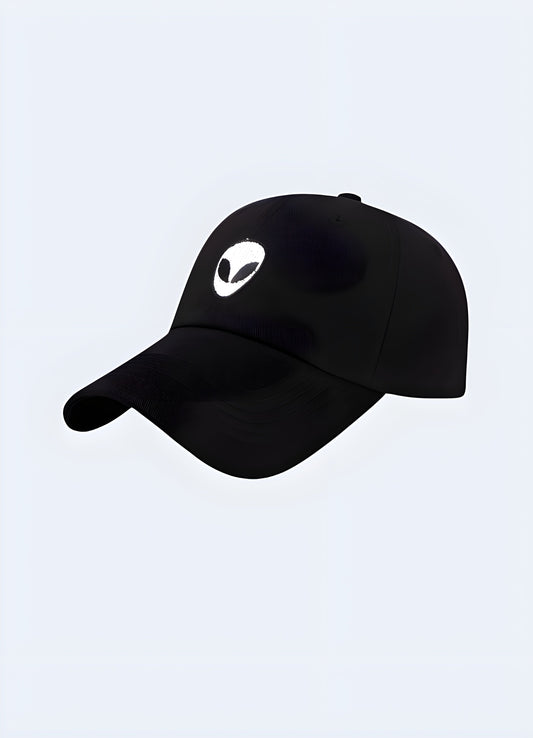 A black snapback cap featuring an alien-themed design, shown from the side to highlight the detailed graphic and the cap's modern, streetwear style Canada.