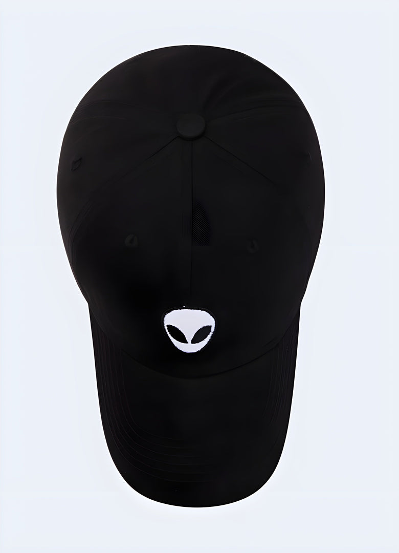 A black snapback cap with an alien-themed design, displayed from the front to showcase the bold graphic on the front panel and the cap’s contemporary streetwear appeal Canada.