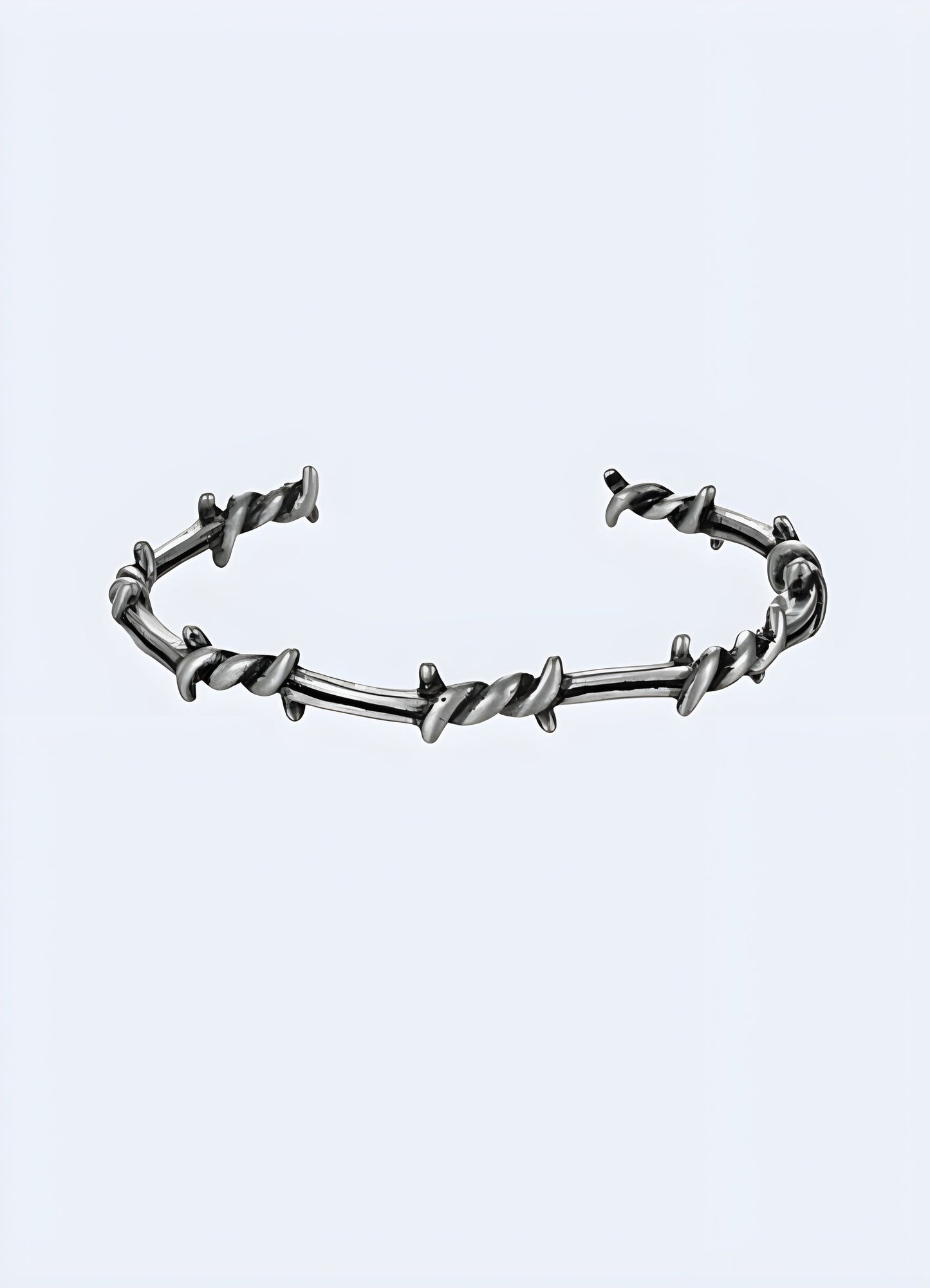 Barbed wire bangle shown from the front view, featuring a detailed barbed wire design with a metallic finish Canada.