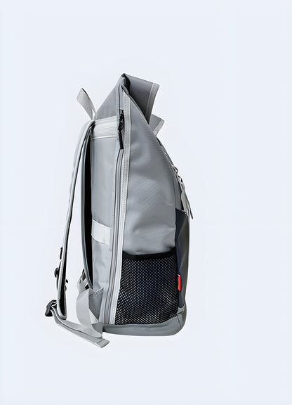 A model wearing a grey reflective backpack, viewed from the side. The backpack features a shiny, reflective surface and a streamlined, modern design Canada.