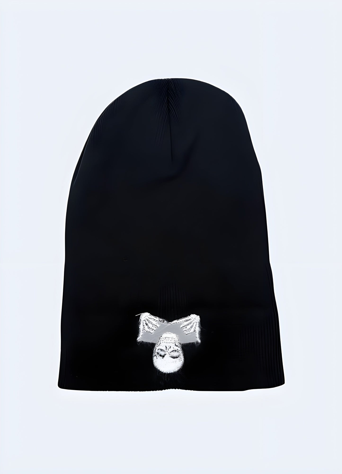 Front view of a black beanie with a skull design, showing the interior lining.