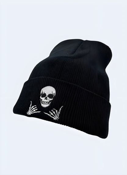 Side view of a black beanie featuring a prominent skull design.