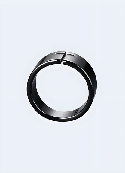 Side view of a black cross ring, highlighting its sleek and modern look.