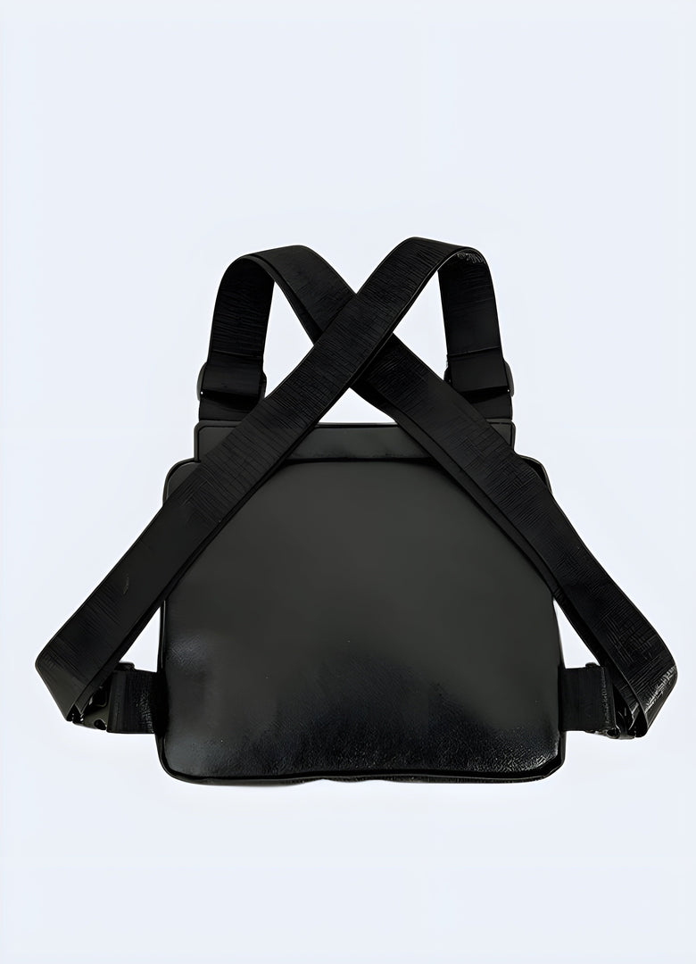 Model wearing a black leather chest bag, viewed from the back. The bag features adjustable straps and a smooth leather finish, with a minimalist design and no visible compartments Canada.