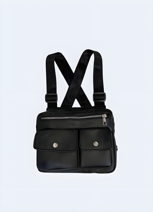 Model wearing a black leather chest bag, viewed from the front. The bag features a smooth leather finish, adjustable straps, and a central compartment with a sleek, minimalist design Canada.