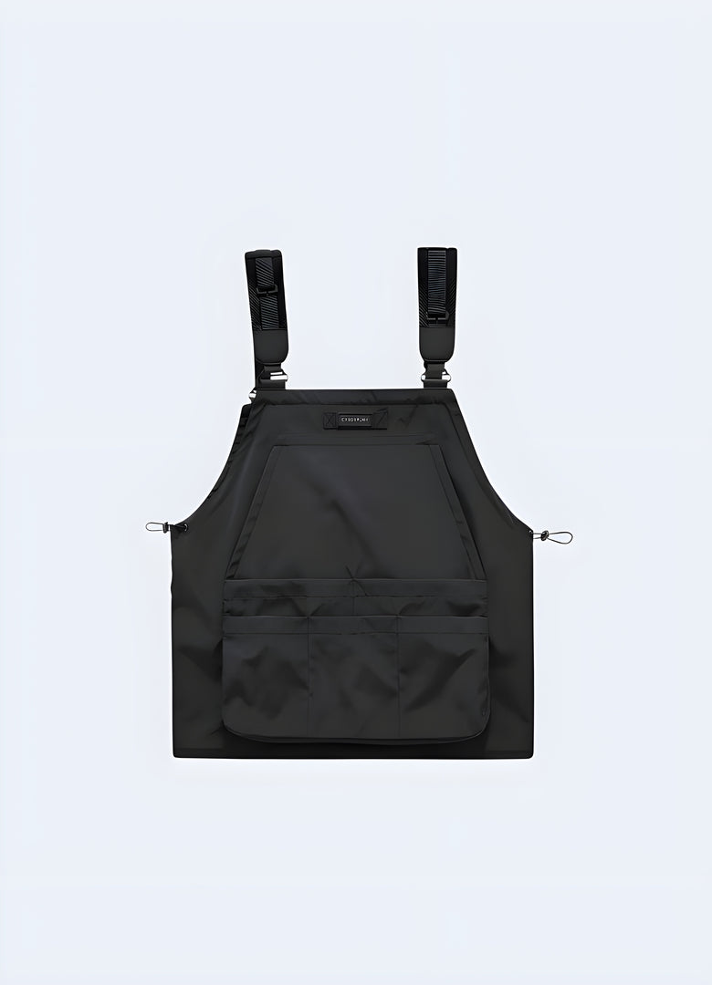 Back view of a black tactical apron showcasing its multiple utility pockets, adjustable fit, and versatile design, suitable for urban fashion and functional wear.