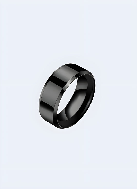 Black titanium ring shown from the front-side view, highlighting its sleek and modern design with a smooth finish.